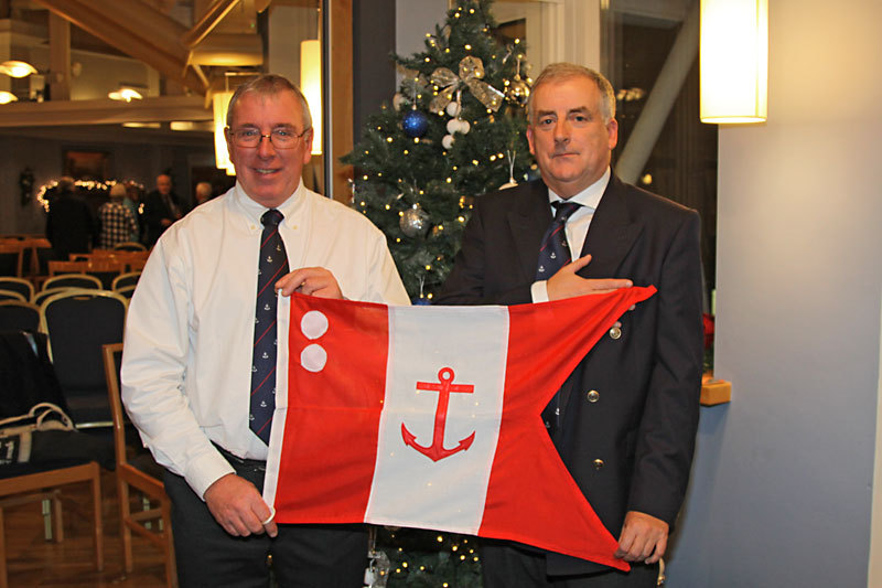 Rear Commodore Ian Byrne accepts his flag from Commodore Joe McPeake