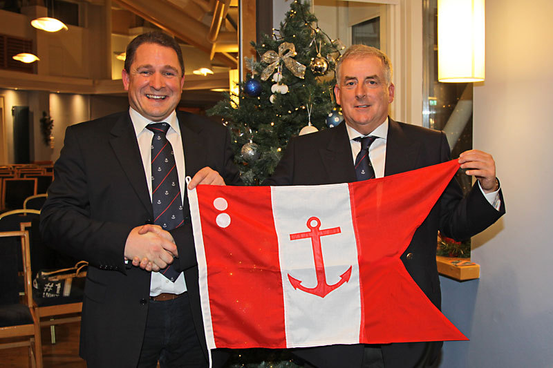 Rear Commodore Jonathan Wormald accepts his flag from the Commodore 