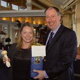Catherine Nora (with 99!) accepts her Brass Monkey prize from Commodore Brian Turvey
