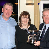 Therese Bermingham (Bite the Bullet) is presented the 'Kumquat Cup' by Fergal Noonan and Commodore Berchmans Gannon