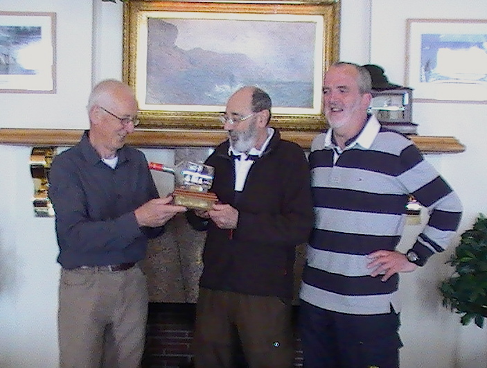 Joe Phelan presents Joe Nolan with the Asgard II trophy while Cruising Class Captain Garry Davis looks on