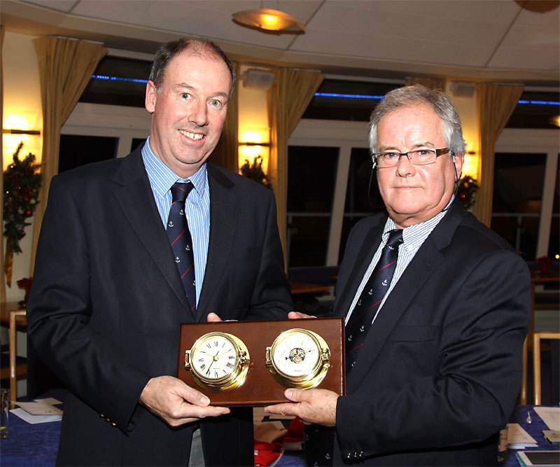 Outgoing Commodore Brian Turvey is presented with a gift on behalf of the club by Commodore Berchmans Gannon