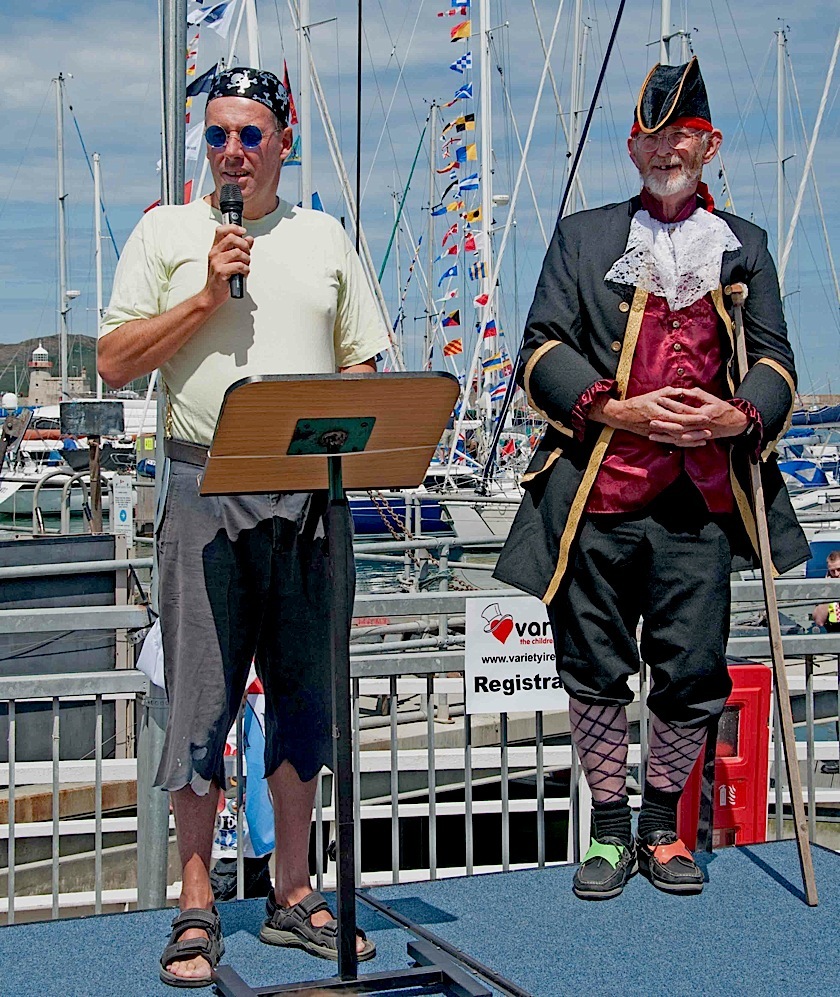Guarded by 'Pirate Pat', Commodore Brian Turvey welcomes the visitors and thanks all concerned