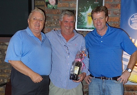 Tony and Barry Gibney present event chairman Dermot Skehan with his prize