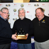 Roy Glynn collects the Liam McGonagle Brass Monkey Trophy from Pat Connolly and David Appleyard